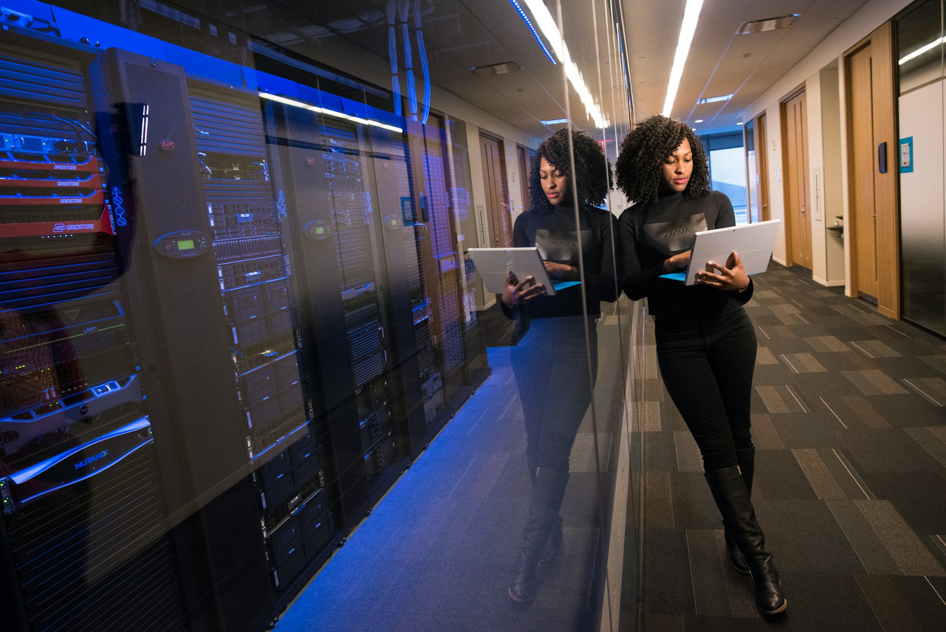 IT professional managing server infrastructure with tablet